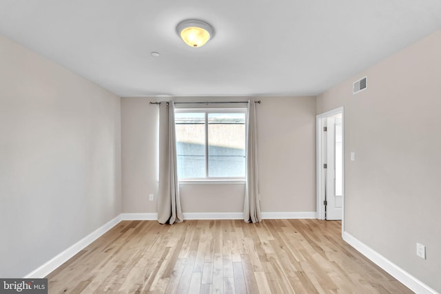 spare room with light hardwood / wood-style flooring