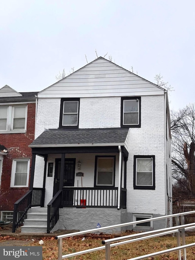 view of front of property with brick siding and a porch