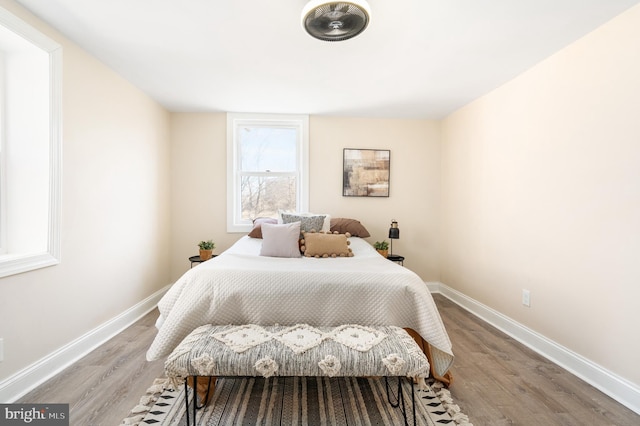 bedroom featuring wood finished floors and baseboards