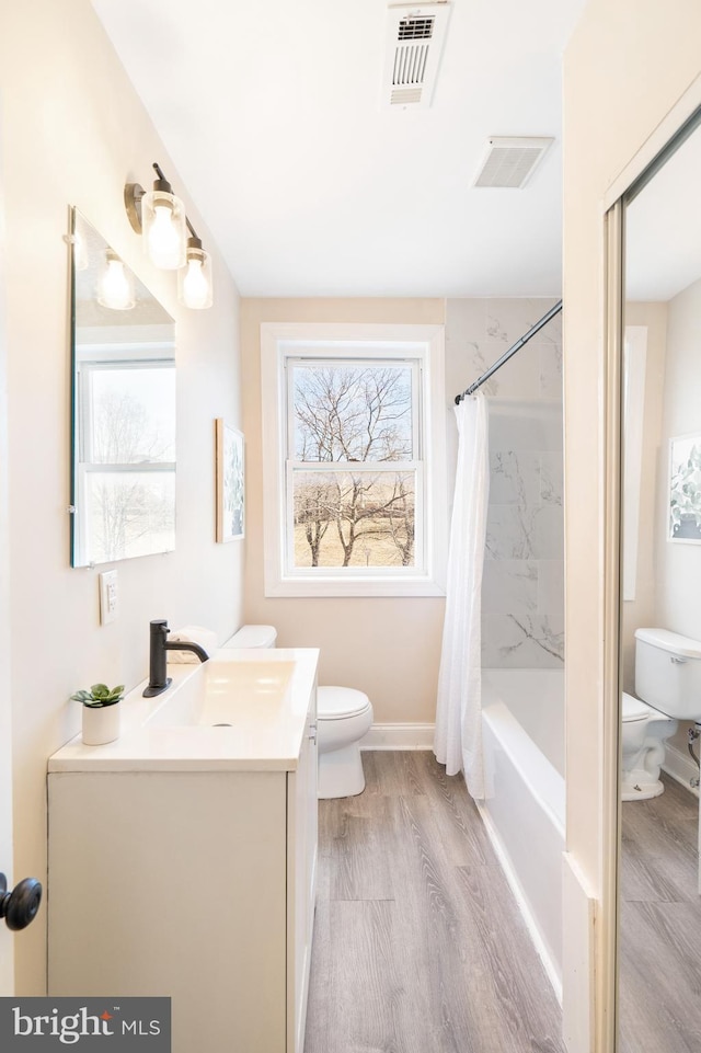 bathroom with visible vents, wood finished floors, vanity, and toilet