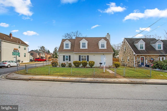 new england style home featuring a front lawn