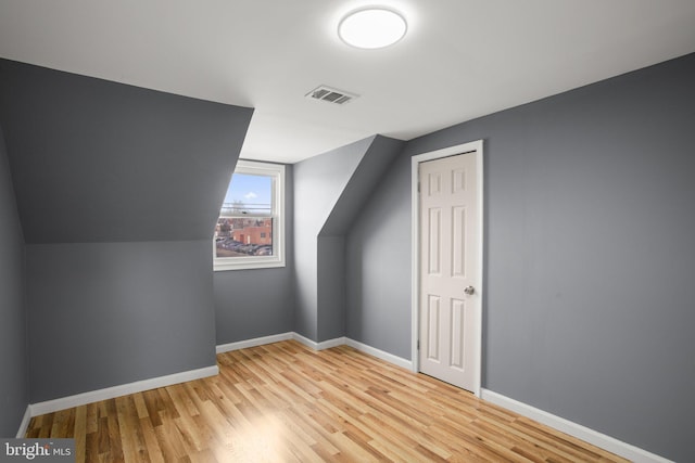 bonus room with light hardwood / wood-style flooring and vaulted ceiling