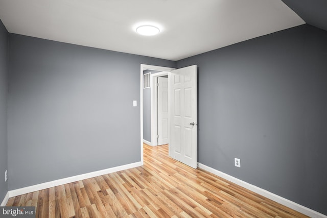 unfurnished room with light wood-type flooring