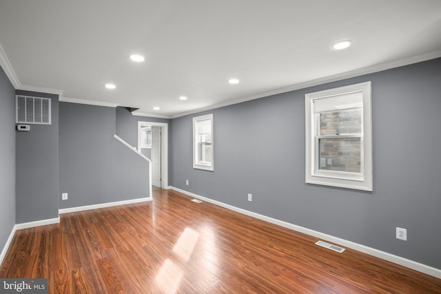 basement featuring crown molding and dark hardwood / wood-style flooring