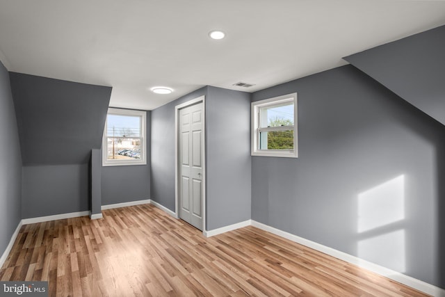 additional living space featuring light wood-type flooring