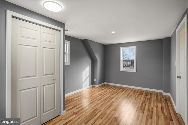 additional living space featuring light wood-type flooring