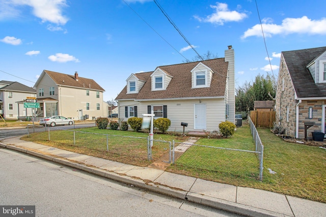 new england style home featuring a front lawn