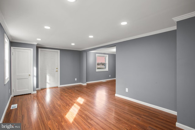 unfurnished room featuring crown molding and wood-type flooring