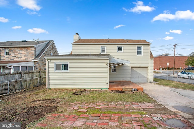 back of house featuring a garage