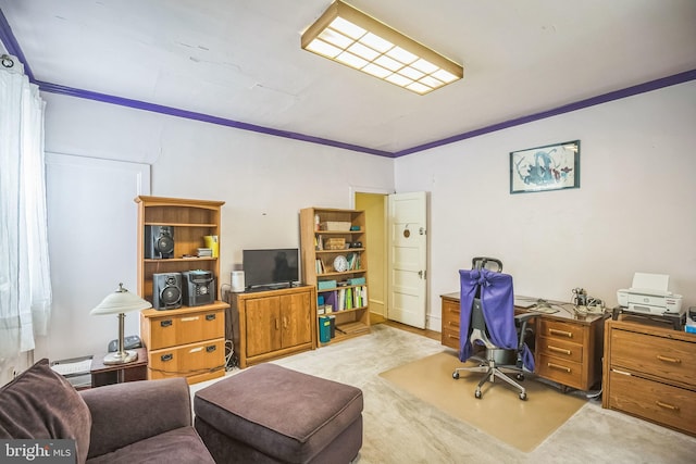 home office with carpet floors and ornamental molding