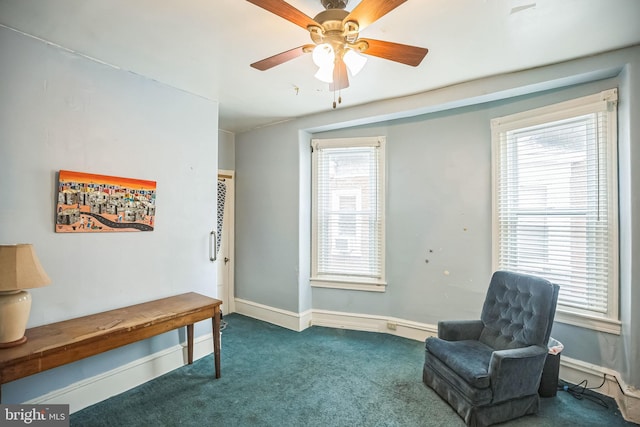 sitting room featuring carpet, a wealth of natural light, and baseboards