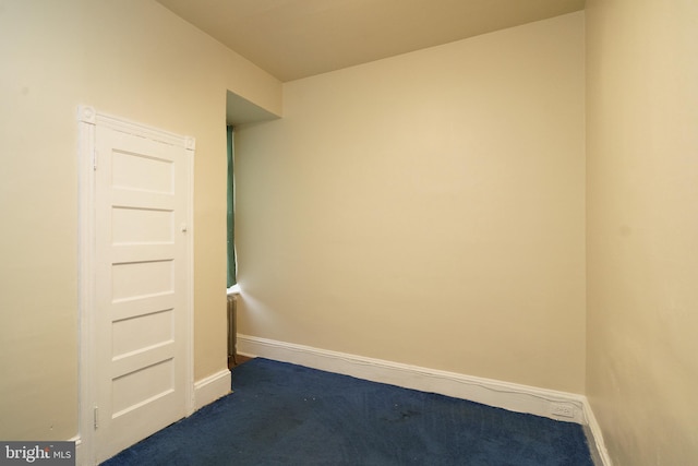 carpeted empty room with baseboards