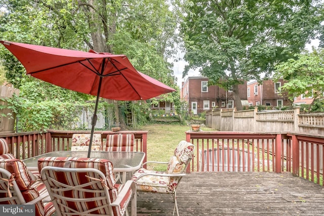 wooden deck featuring a yard