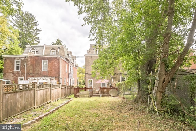 view of yard featuring fence and a wooden deck