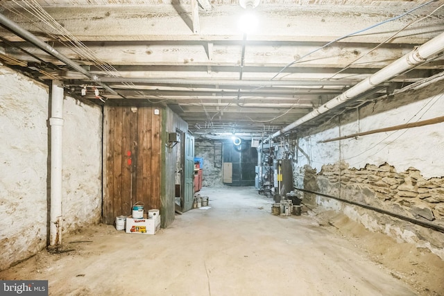 unfinished basement featuring water heater