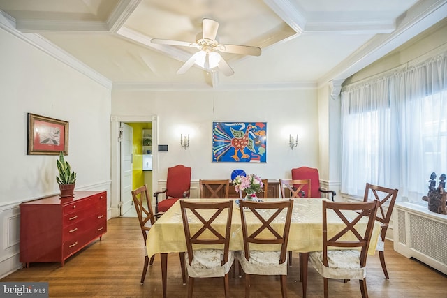 dining space featuring crown molding, radiator heating unit, ceiling fan, wood finished floors, and beamed ceiling