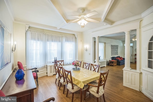 dining area featuring crown molding, ceiling fan, ornate columns, and wood finished floors