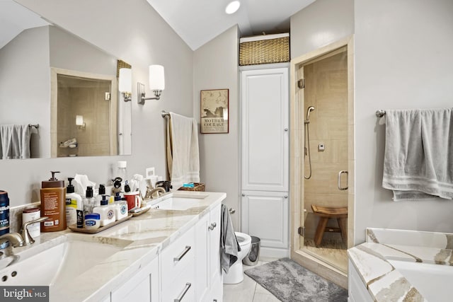 bathroom with independent shower and bath, vaulted ceiling, tile patterned flooring, and vanity