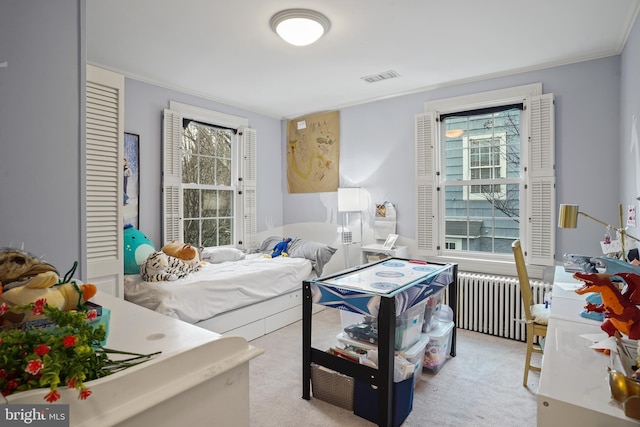 carpeted bedroom with multiple windows, crown molding, and radiator heating unit