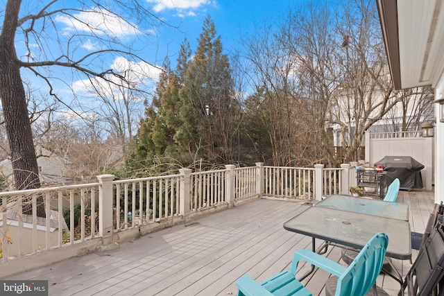 wooden terrace with a grill