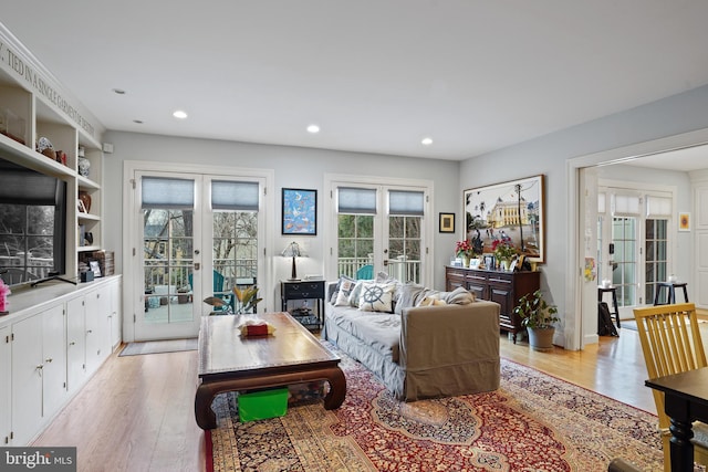 living room featuring french doors and light hardwood / wood-style floors