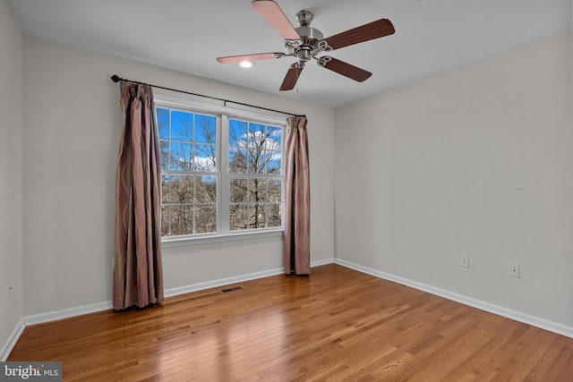 unfurnished room with ceiling fan and light wood-type flooring