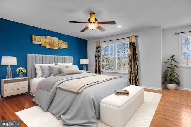 bedroom with hardwood / wood-style flooring, radiator, and ceiling fan