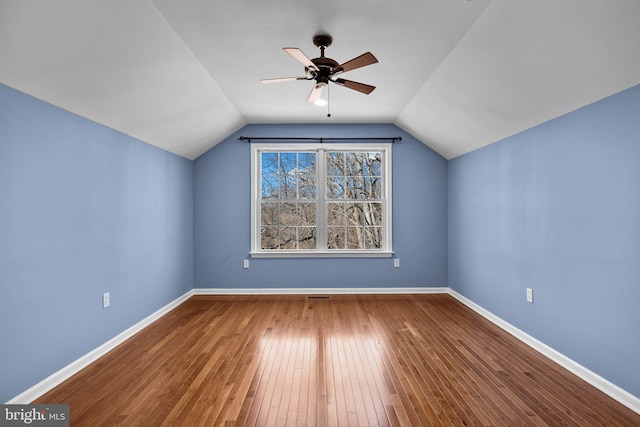 additional living space with wood-type flooring, lofted ceiling, and ceiling fan