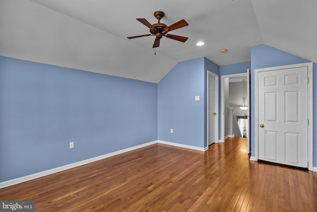 additional living space featuring lofted ceiling, hardwood / wood-style flooring, and ceiling fan