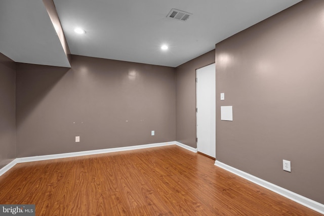 basement with hardwood / wood-style flooring