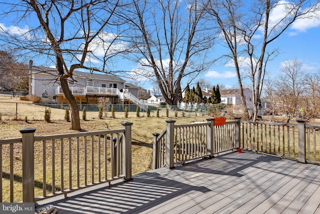 wooden deck featuring a lawn