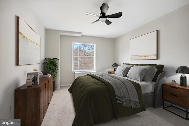 bedroom featuring light colored carpet and ceiling fan