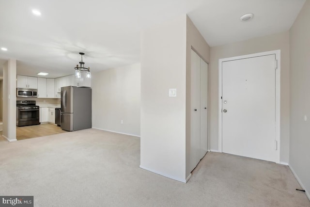 view of carpeted foyer entrance