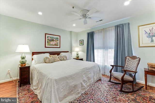 bedroom featuring recessed lighting, visible vents, a ceiling fan, wood finished floors, and baseboards