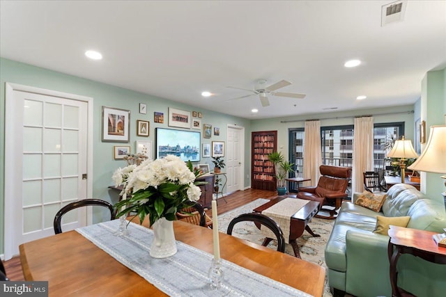 dining space with a ceiling fan, wood finished floors, visible vents, and recessed lighting