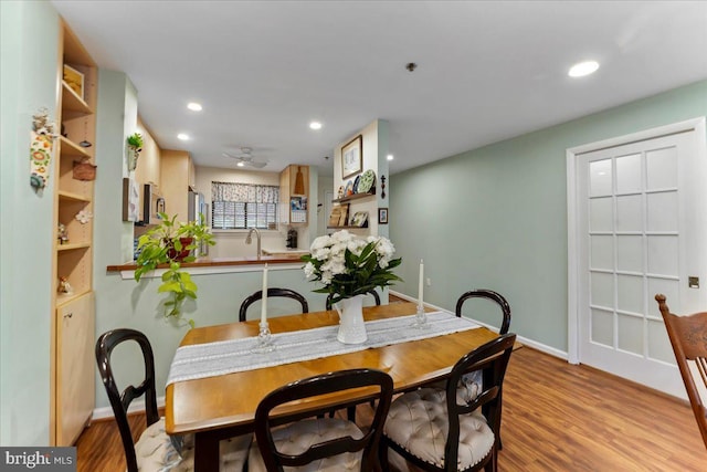 dining room featuring recessed lighting, baseboards, and wood finished floors