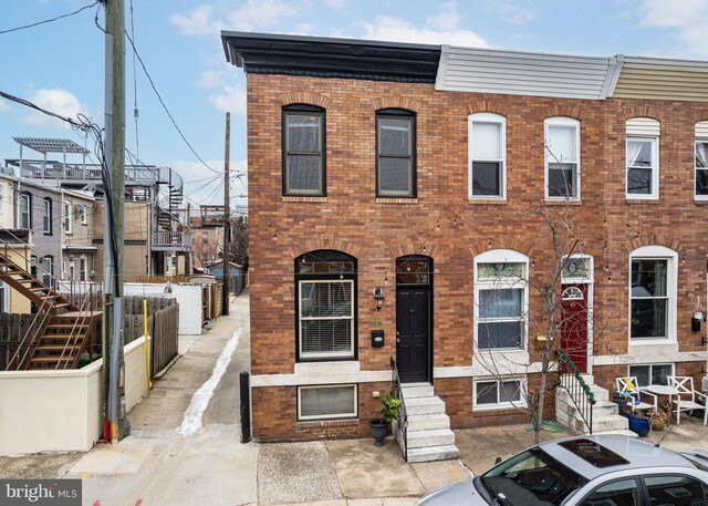 multi unit property featuring brick siding and stairway