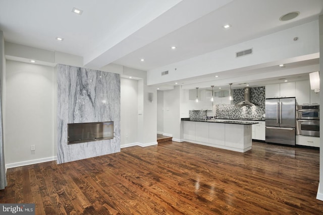 unfurnished living room with dark wood-type flooring and a fireplace