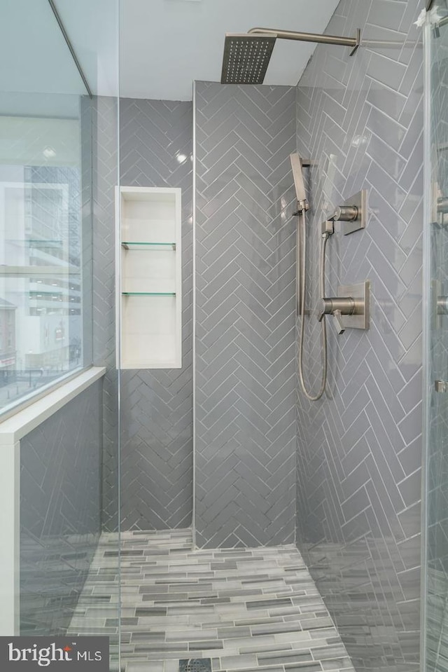 bathroom with a tile shower