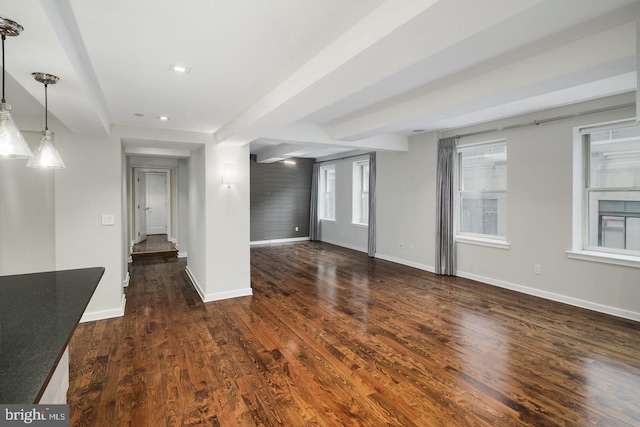 unfurnished living room with dark wood-type flooring