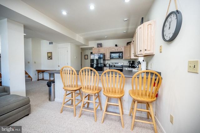 3084 Lake Shore Dr, Oakland, MD 21550 - kitchen featuring a peninsula, a kitchen breakfast bar, light brown cabinets, and black appliances