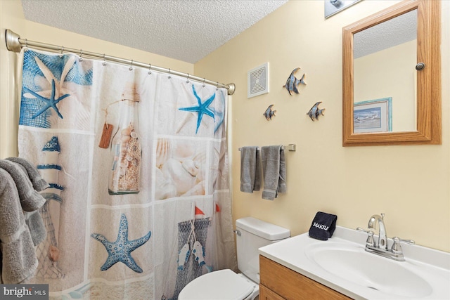 bathroom featuring vanity, toilet, a textured ceiling, and walk in shower