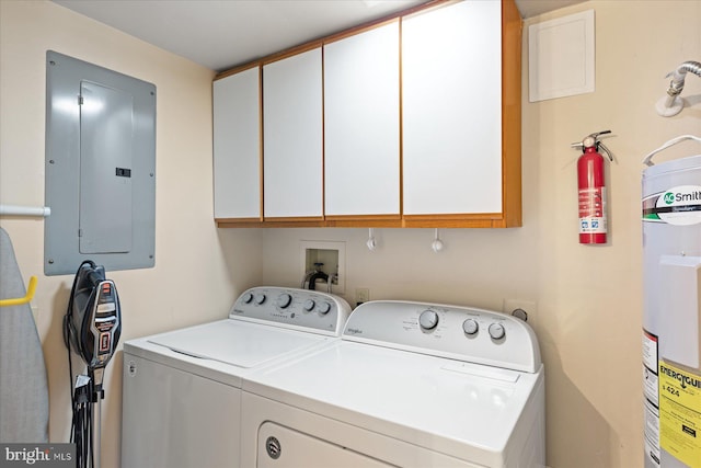 laundry room featuring water heater, independent washer and dryer, electric panel, and cabinets