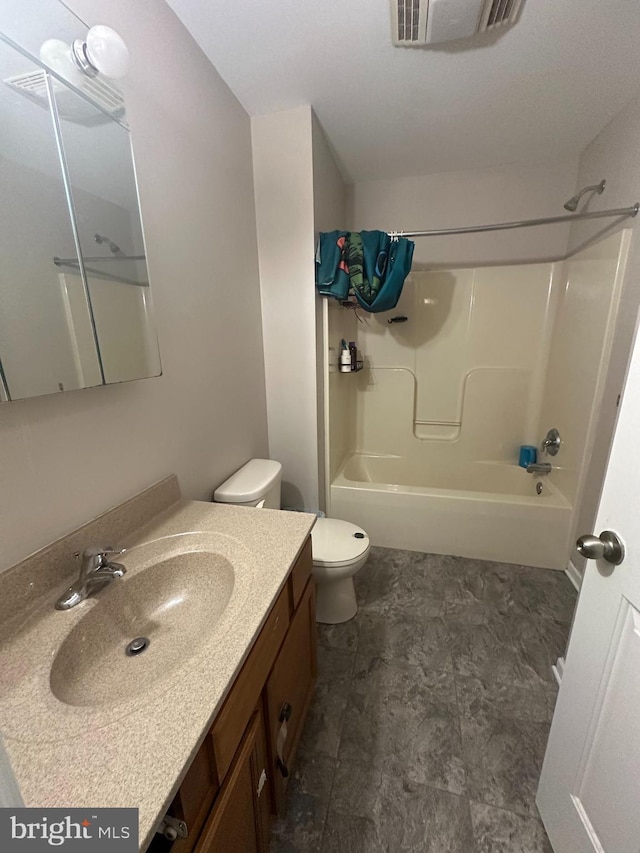 bathroom with toilet, vanity, and shower / tub combination