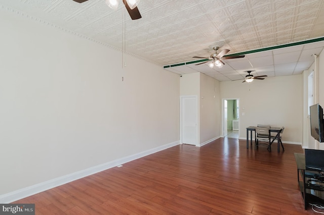 spare room with dark hardwood / wood-style flooring and ceiling fan