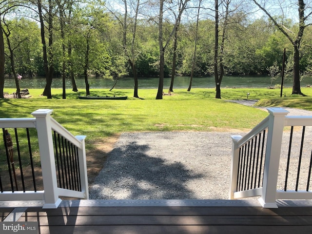 exterior space featuring a water view and a lawn