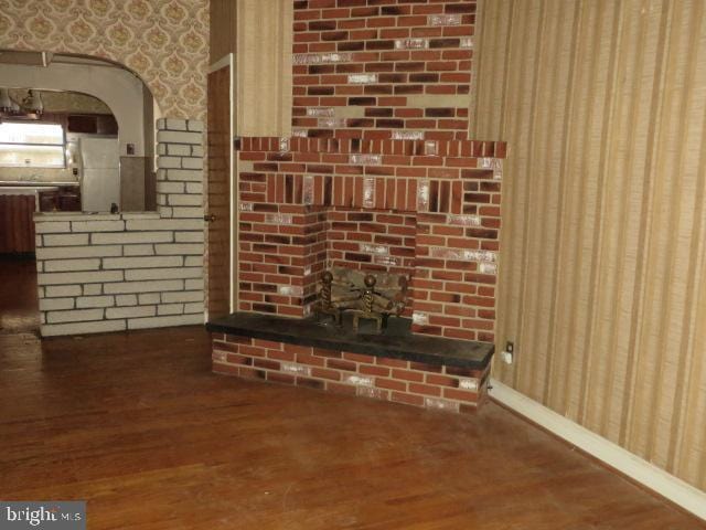 unfurnished living room with dark wood-type flooring