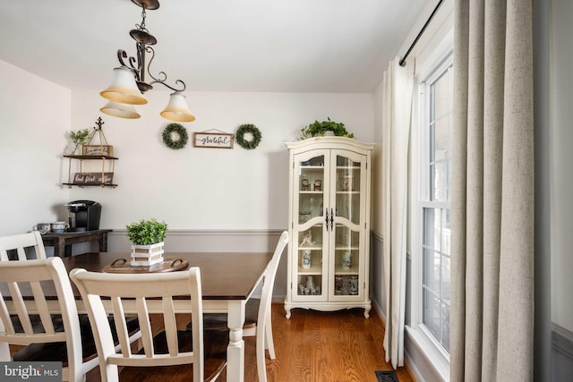 dining area with wood finished floors and visible vents