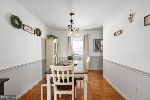 dining room featuring baseboards and wood finished floors