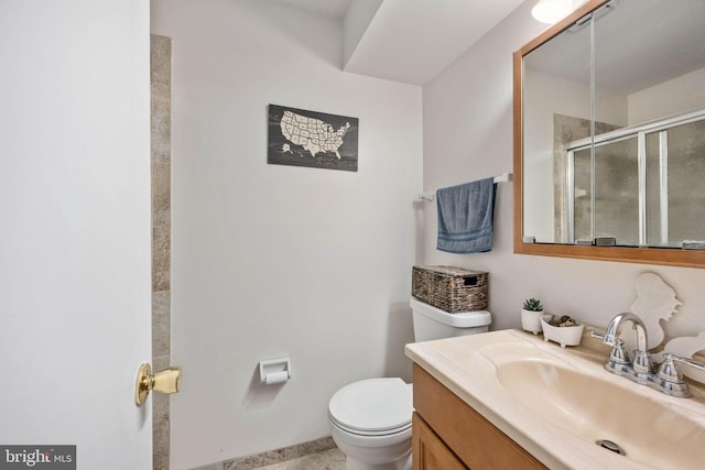 bathroom with vanity, toilet, and a shower stall